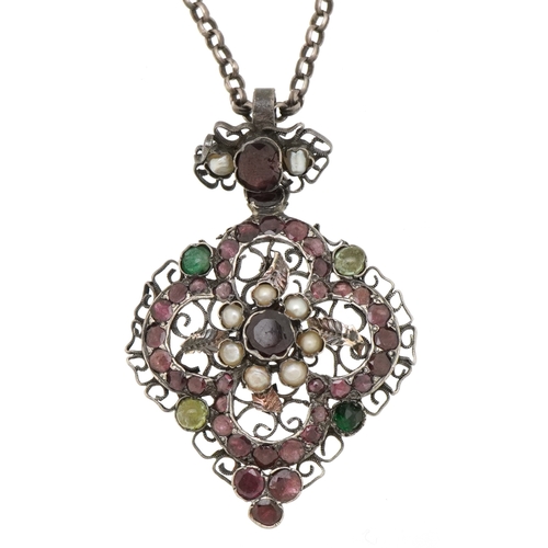  An Austro-Hungarian unmarked silver garnet and seed pearl pendant on a silver necklace, 4.3cm high a... 