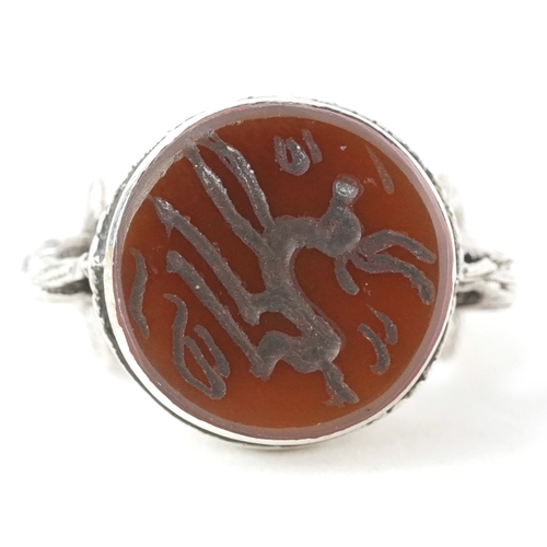 3448 - A Persian unmarked silver ring with an intaglio hardstone seal, size N/O, 9.6g.