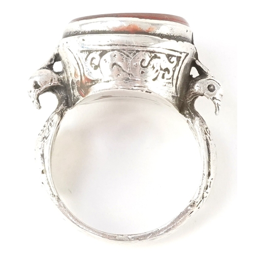 3448 - A Persian unmarked silver ring with an intaglio hardstone seal, size N/O, 9.6g.