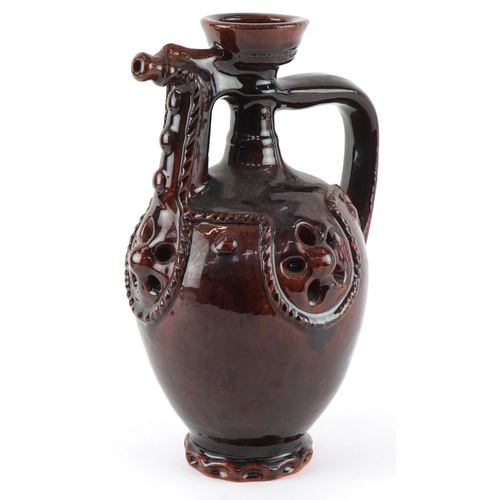 333 - A 20th century treacle glazed terracotta ewer, 24cm high.