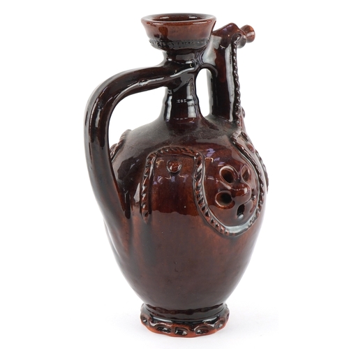 333 - A 20th century treacle glazed terracotta ewer, 24cm high.