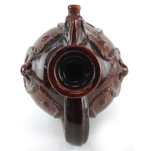 333 - A 20th century treacle glazed terracotta ewer, 24cm high.