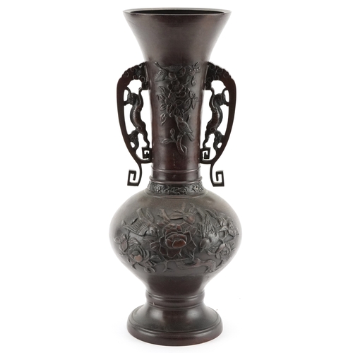 562 - A Japanese bronze baluster vase with pierced handles and floral decoration, 39cm high.