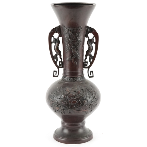 562 - A Japanese bronze baluster vase with pierced handles and floral decoration, 39cm high.