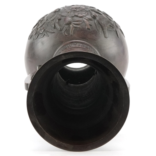 562 - A Japanese bronze baluster vase with pierced handles and floral decoration, 39cm high.