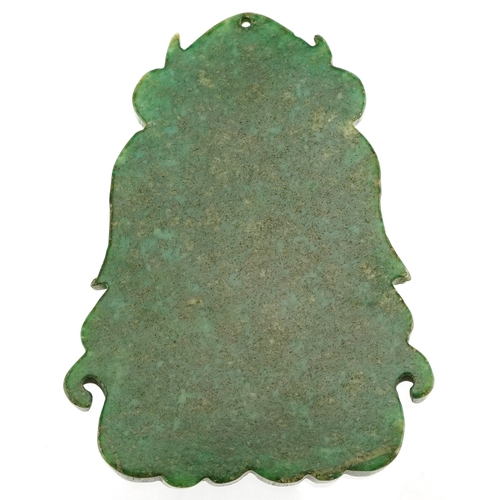 457 - A Chinese green stone pendant carved with dragons, 8cm high, 78.6g.