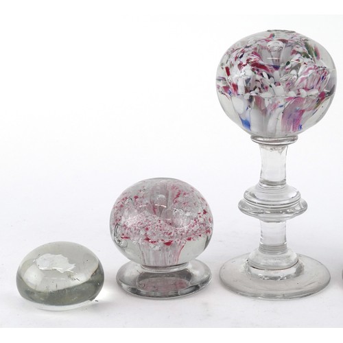 440 - A collection of glass paperweights including footed examples and an opalescent fish, the largest 23c... 
