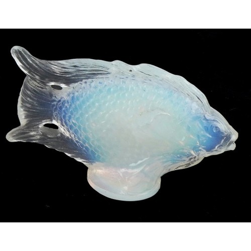 440 - A collection of glass paperweights including footed examples and an opalescent fish, the largest 23c... 