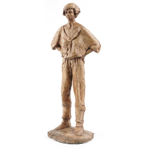 113 - A late 20th century resin sculpture of a young man, 71cm high.