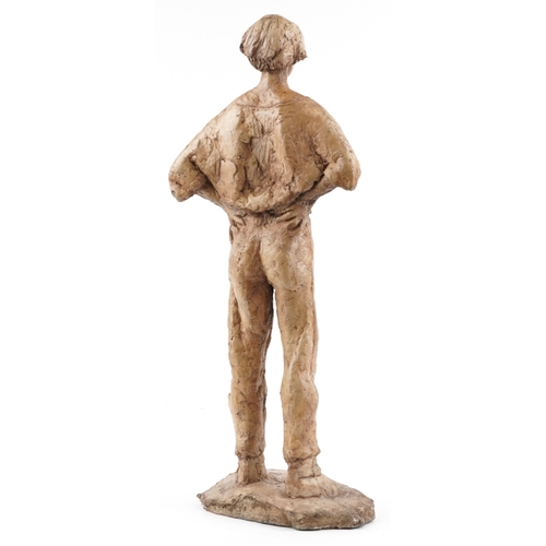113 - A late 20th century resin sculpture of a young man, 71cm high.