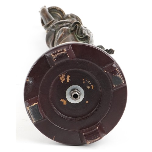 101 - A 20th century brown patinated bronze table lamp base in the form of a maiden carrying a torch, moun... 