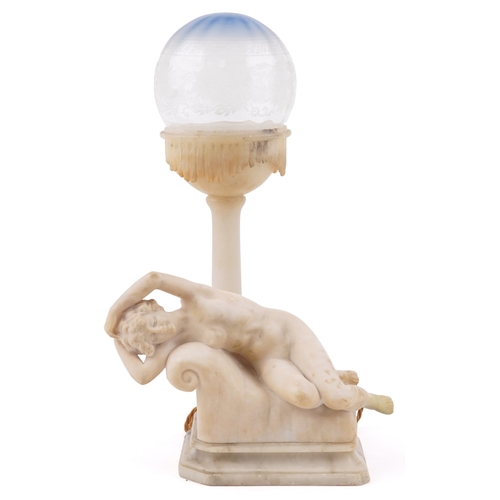 110 - An early 20th century carved alabaster table lamp base modelled as a reclining female nude together ... 