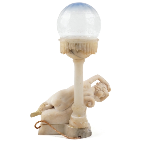 110 - An early 20th century carved alabaster table lamp base modelled as a reclining female nude together ... 
