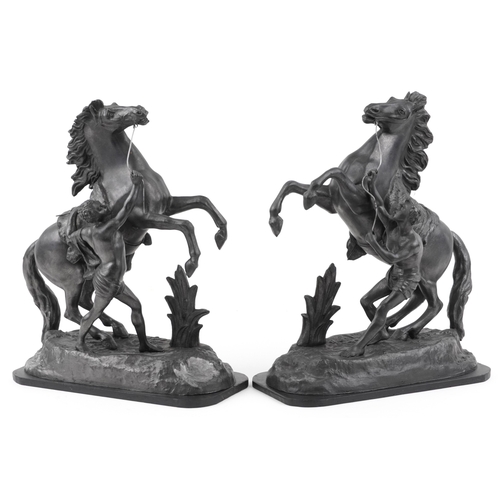 104 - A pair of late 20th century bronzed spelter Marly horses, each mounted on an ebonised plinth base, 4... 