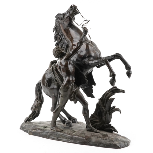 106 - After Guillaume Coustou (1677-1746) - A large brown patinated bronze 'Marly Horse and Groom', signed... 