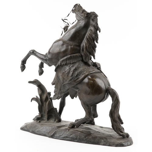 106 - After Guillaume Coustou (1677-1746) - A large brown patinated bronze 'Marly Horse and Groom', signed... 