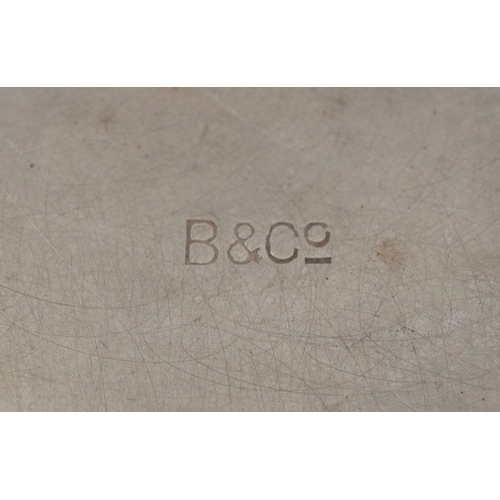 3702 - A silver quaich with twin handles and engraved monogram, 4cm high x 15cm wide, 69.8g.