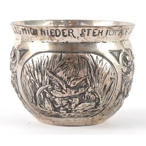 3716 - A German silver cup decorated with panels embossed with birds and foliage, inscribed 'Drink me up an... 