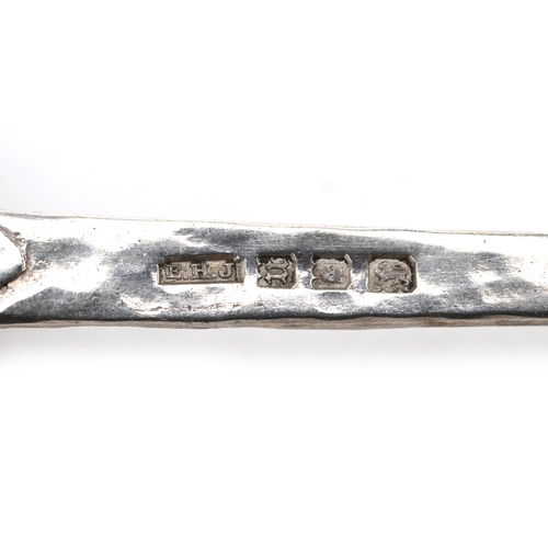 3699 - Two early 20th century silver spoons including a planished example, London 1928, the largest 12.9cm ... 