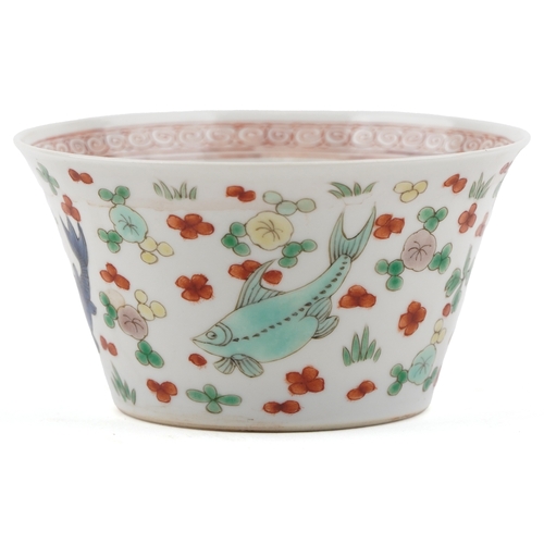 197 - A Chinese porcelain tea bowl hand painted in the famille verte palette with fish and iron red interi... 