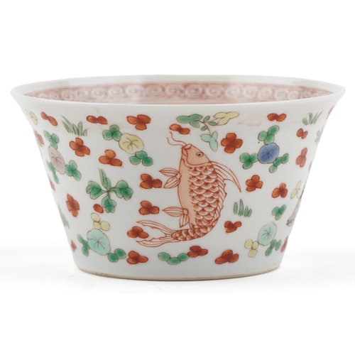 197 - A Chinese porcelain tea bowl hand painted in the famille verte palette with fish and iron red interi... 