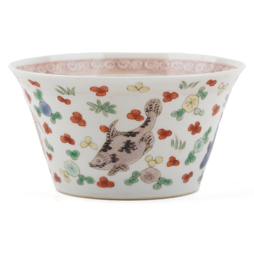 197 - A Chinese porcelain tea bowl hand painted in the famille verte palette with fish and iron red interi... 