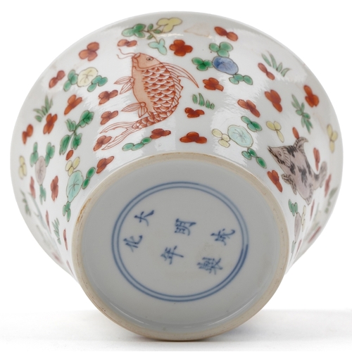 197 - A Chinese porcelain tea bowl hand painted in the famille verte palette with fish and iron red interi... 