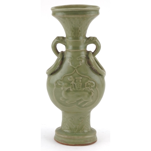 351 - A Chinese porcelain celadon glazed vase with ring turned handles decorated in relief with mythical a... 