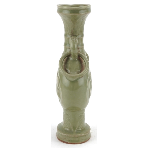 351 - A Chinese porcelain celadon glazed vase with ring turned handles decorated in relief with mythical a... 