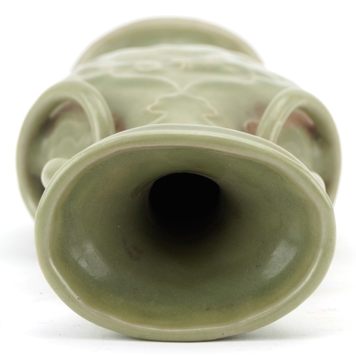 351 - A Chinese porcelain celadon glazed vase with ring turned handles decorated in relief with mythical a... 