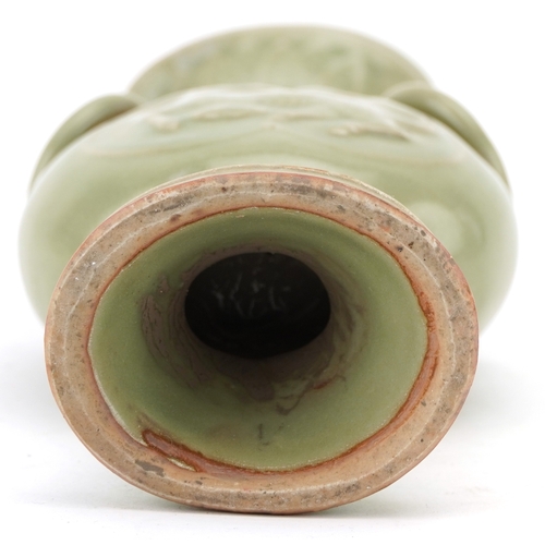 351 - A Chinese porcelain celadon glazed vase with ring turned handles decorated in relief with mythical a... 