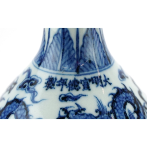 136 - A Chinese blue and white porcelain ewer hand painted with dragons amongst clouds, six figure charact... 