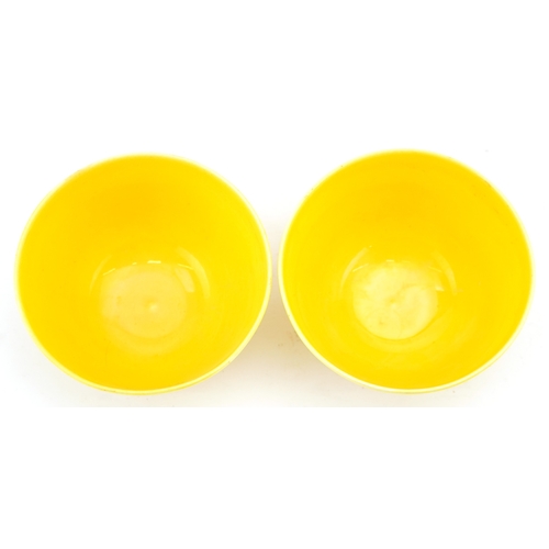 1596 - A pair of Chinese yellow glazed porcelain bowls with incised dragons, six figure character marks to ... 