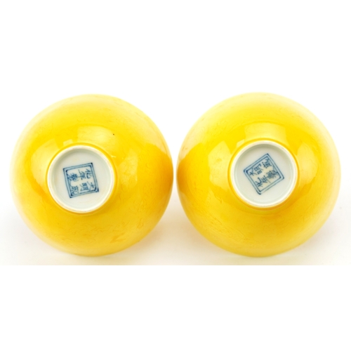 1596 - A pair of Chinese yellow glazed porcelain bowls with incised dragons, six figure character marks to ... 