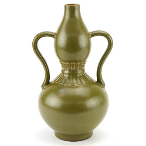 193 - A Chinese porcelain teadust glazed double gourd vase with twin handles, six figure character marks t... 