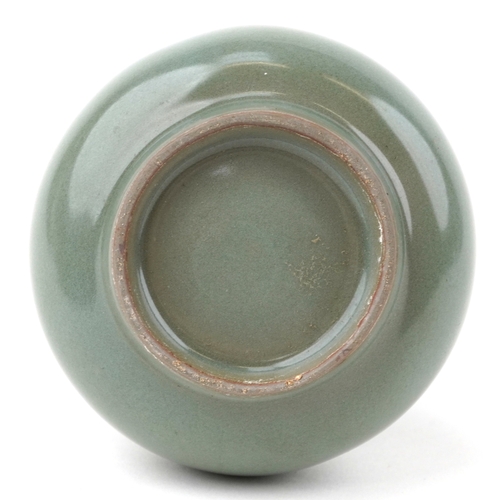 1571 - A Chinese porcelain celadon glaze bottleneck vase with ears, 14cm high.