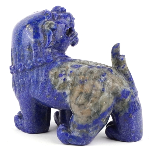 1548 - A Chinese lapis lazuli carved temple dog in a standing position with tail raised, 7cm high x 10cm in... 