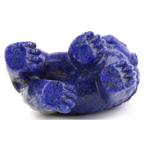 1548 - A Chinese lapis lazuli carved temple dog in a standing position with tail raised, 7cm high x 10cm in... 