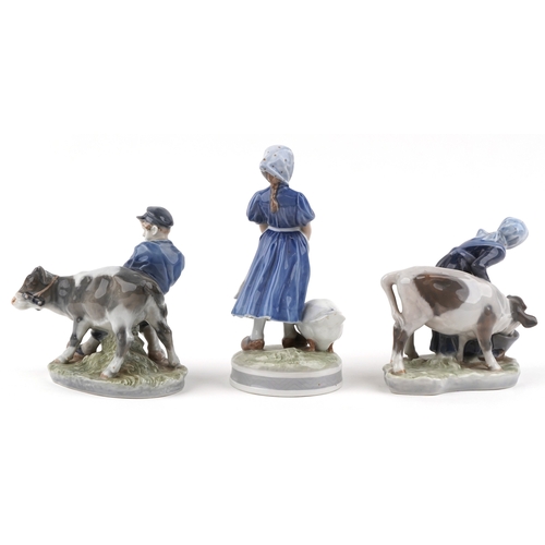 595 - Three Royal Copenhagen Danish porcelain figure groups of farmers, the largest 23cm high.