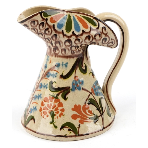 1660 - A mid 20th century studio pottery jug with hand painted decoration, 21cm high.