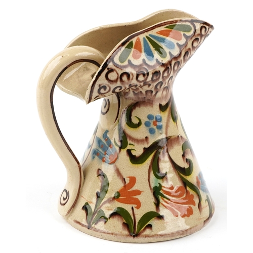 1660 - A mid 20th century studio pottery jug with hand painted decoration, 21cm high.
