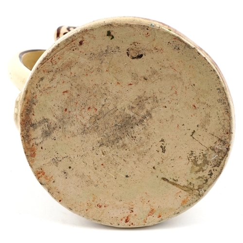 1660 - A mid 20th century studio pottery jug with hand painted decoration, 21cm high.