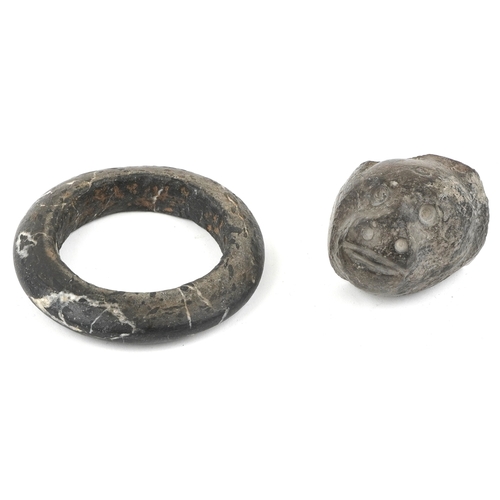 1684 - A carved stone bangle, possibly African Dogon tribe, 10cm in diameter together with a stone fragment... 