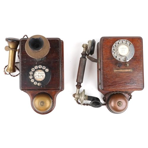 572 - Two similar early 20th century oak cased wall mounted telephones, each with brass receivers, the dia... 