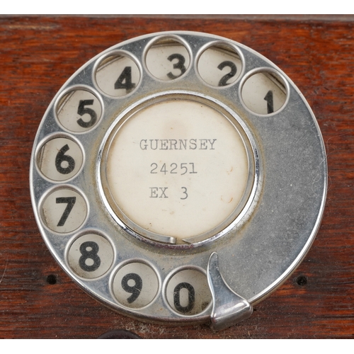 572 - Two similar early 20th century oak cased wall mounted telephones, each with brass receivers, the dia... 