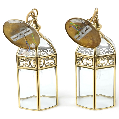 319 - A pair of gilt brass hanging lantern light fittings with bevelled glass panels, 45cm high.