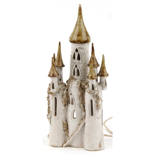 475 - A studio pottery novelty table lamp base in the form of a castle, possibly by Sue Pritchard, 41cm hi... 