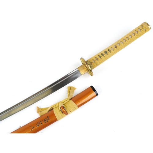 2856 - A decorative Japanese Katana sword with a string bound shagreen grip, the sheath signed, overall 103... 