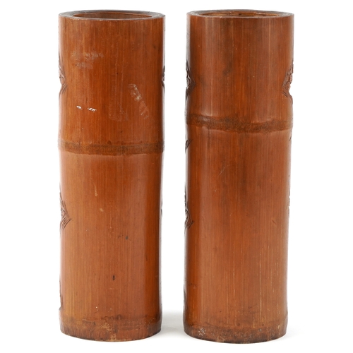 207 - A pair of Chinese bamboo brush pots carved with figures and pagodas, 35cm high.
