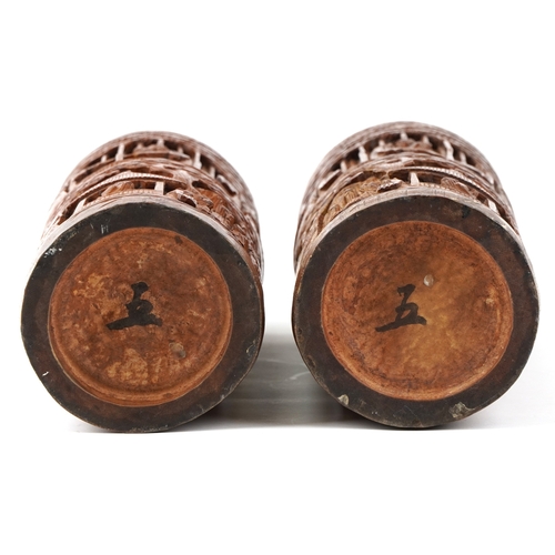 207 - A pair of Chinese bamboo brush pots carved with figures and pagodas, 35cm high.